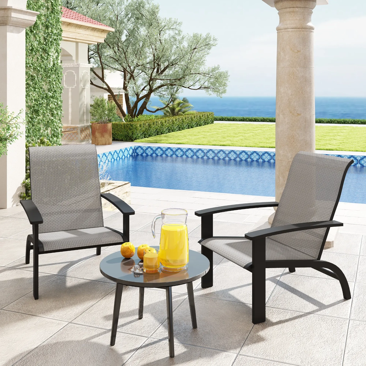 Modern outdoor lounge chairs near a poolside table with refreshing beverages.