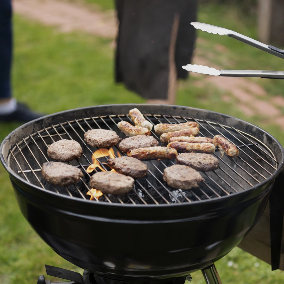 Placing food directly over lit coals for quick searing and high-heat cooking.