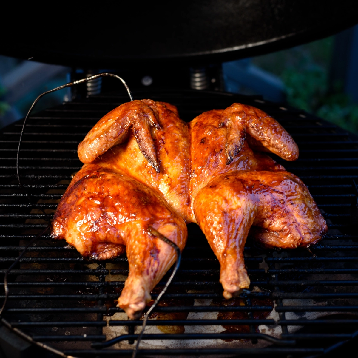 Cooking food beside, not over, hot coals for slow, indirect heat and even doneness.