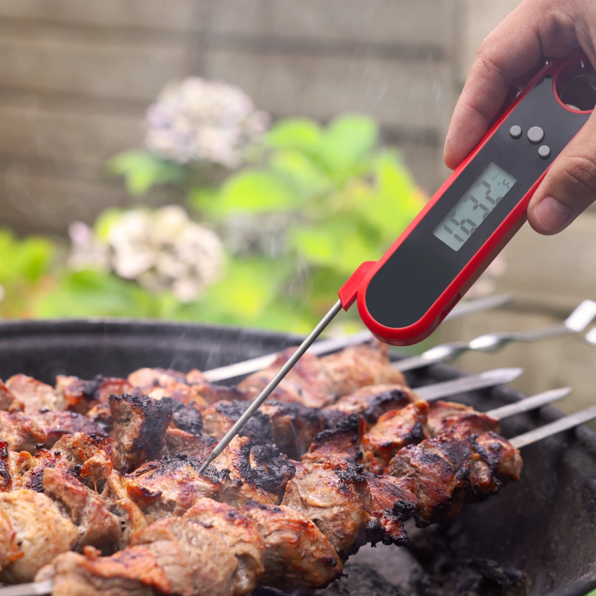 Adjusting vents and coal placement to maintain consistent grilling temperature throughout cooking.