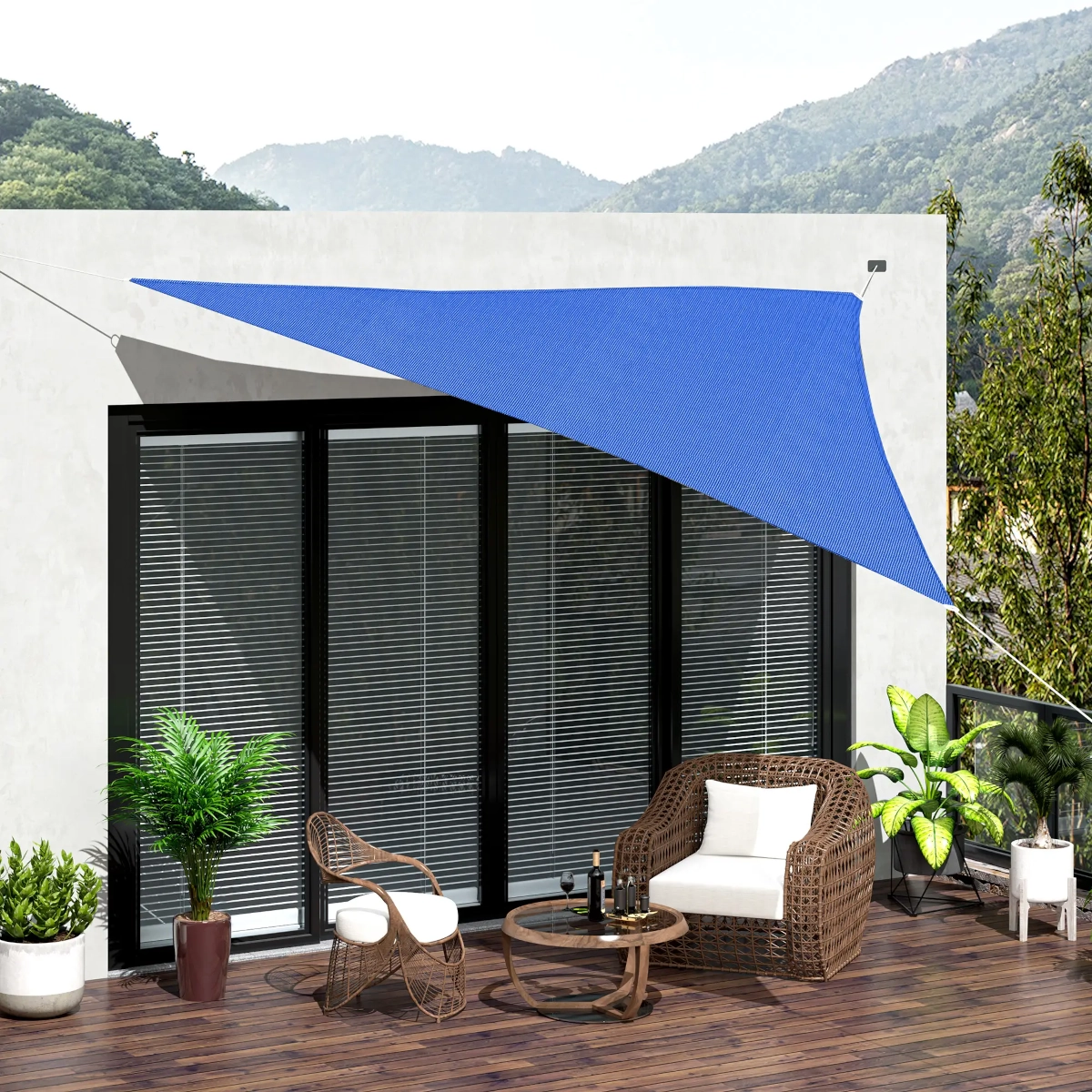 Triangular blue shade sail covering outdoor patio with scenic view and seating.