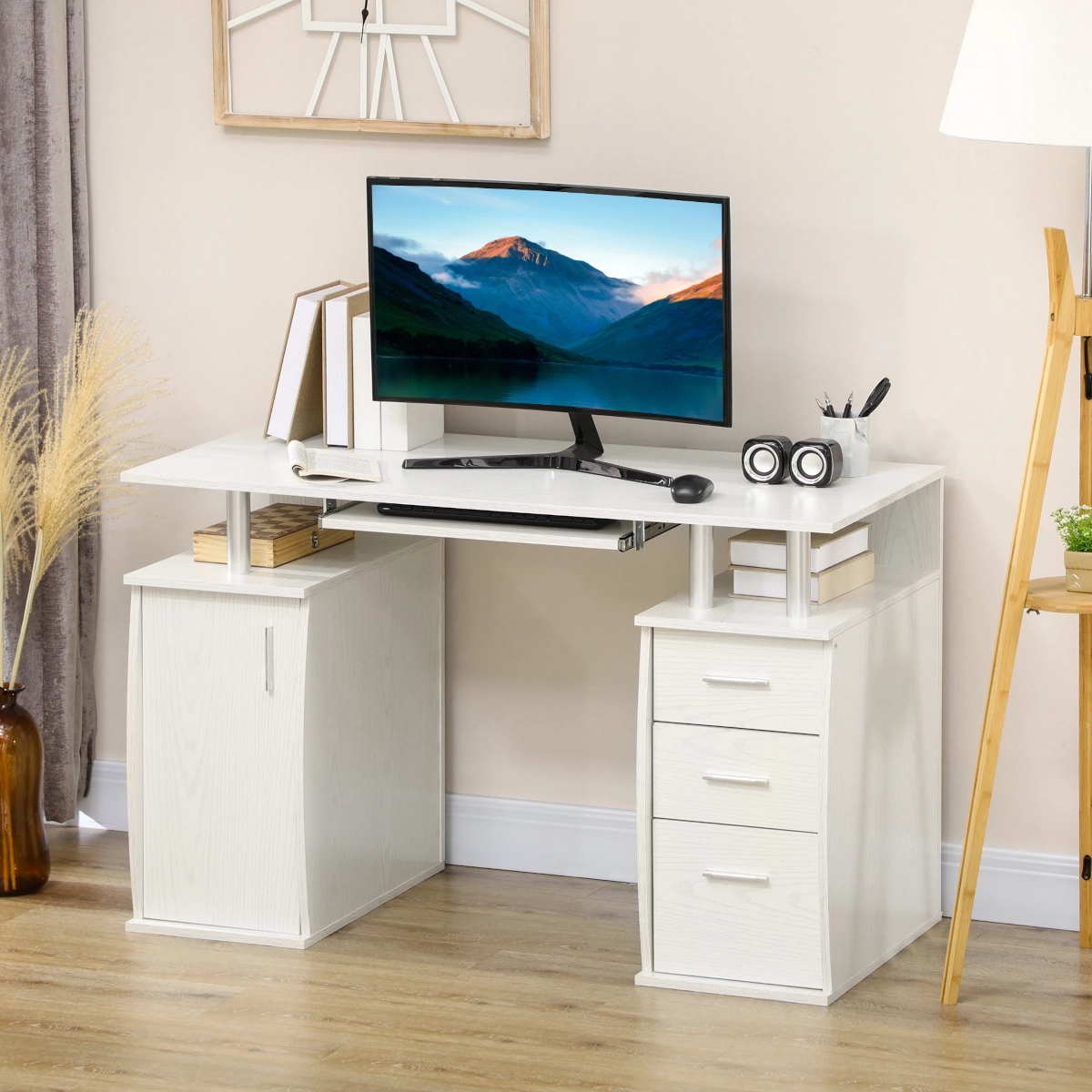 White computer desk with monitor, books, drawers, and neutral decor accents
