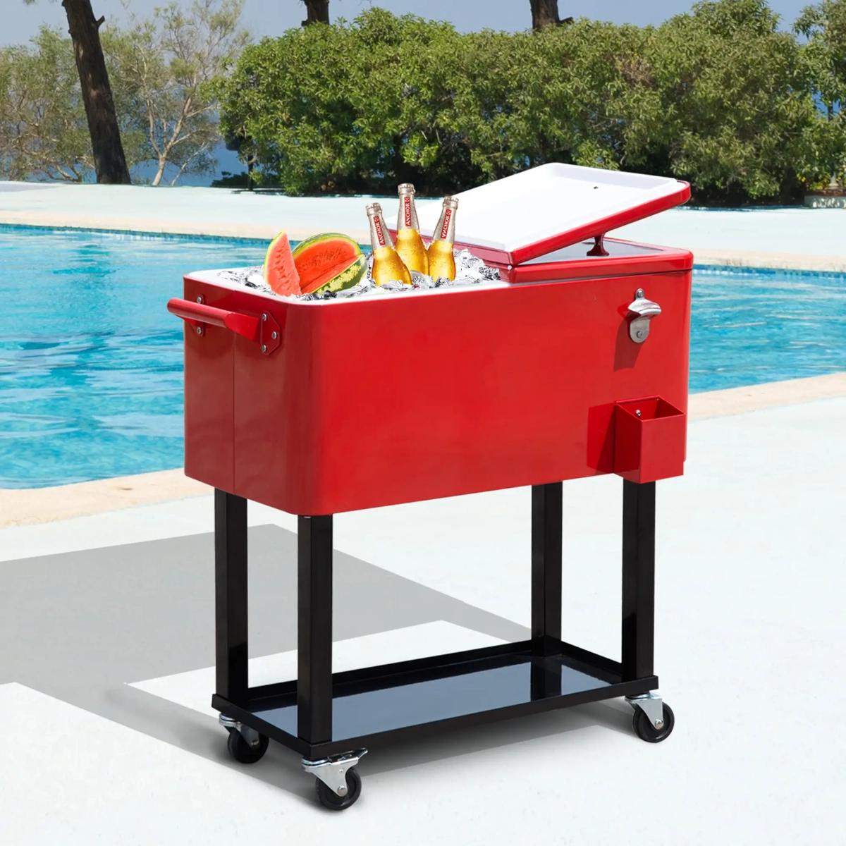 Red patio cooler cart by a pool, filled with ice, bottled drinks, and watermelon slices.