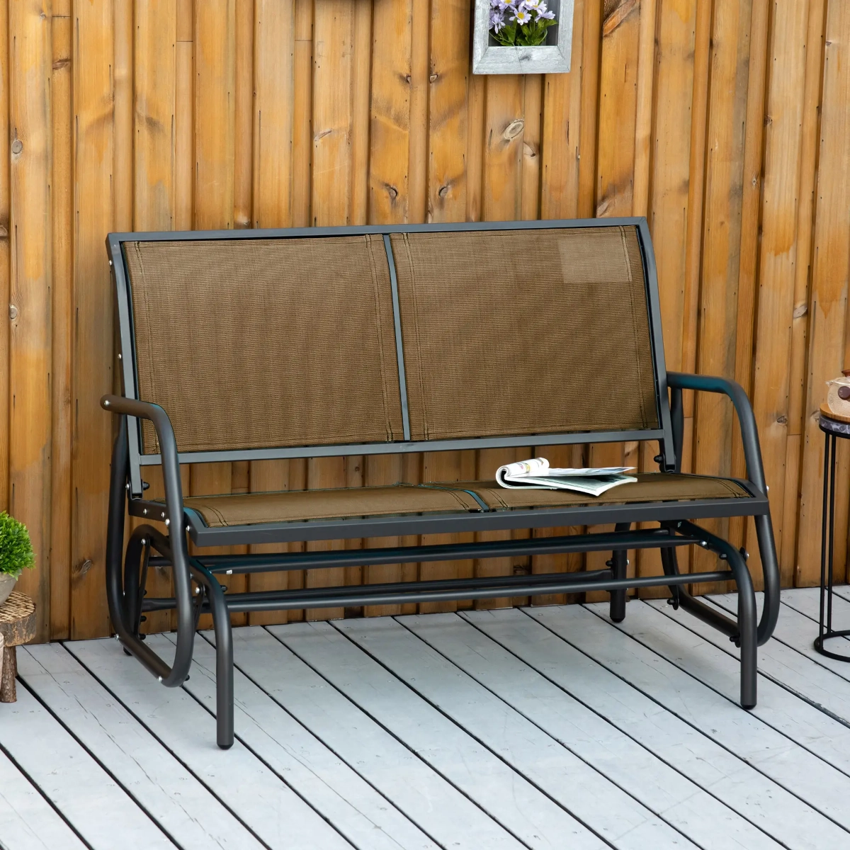 Heavy-duty double glider swing chair perfect for relaxing and enjoying outdoor spaces.