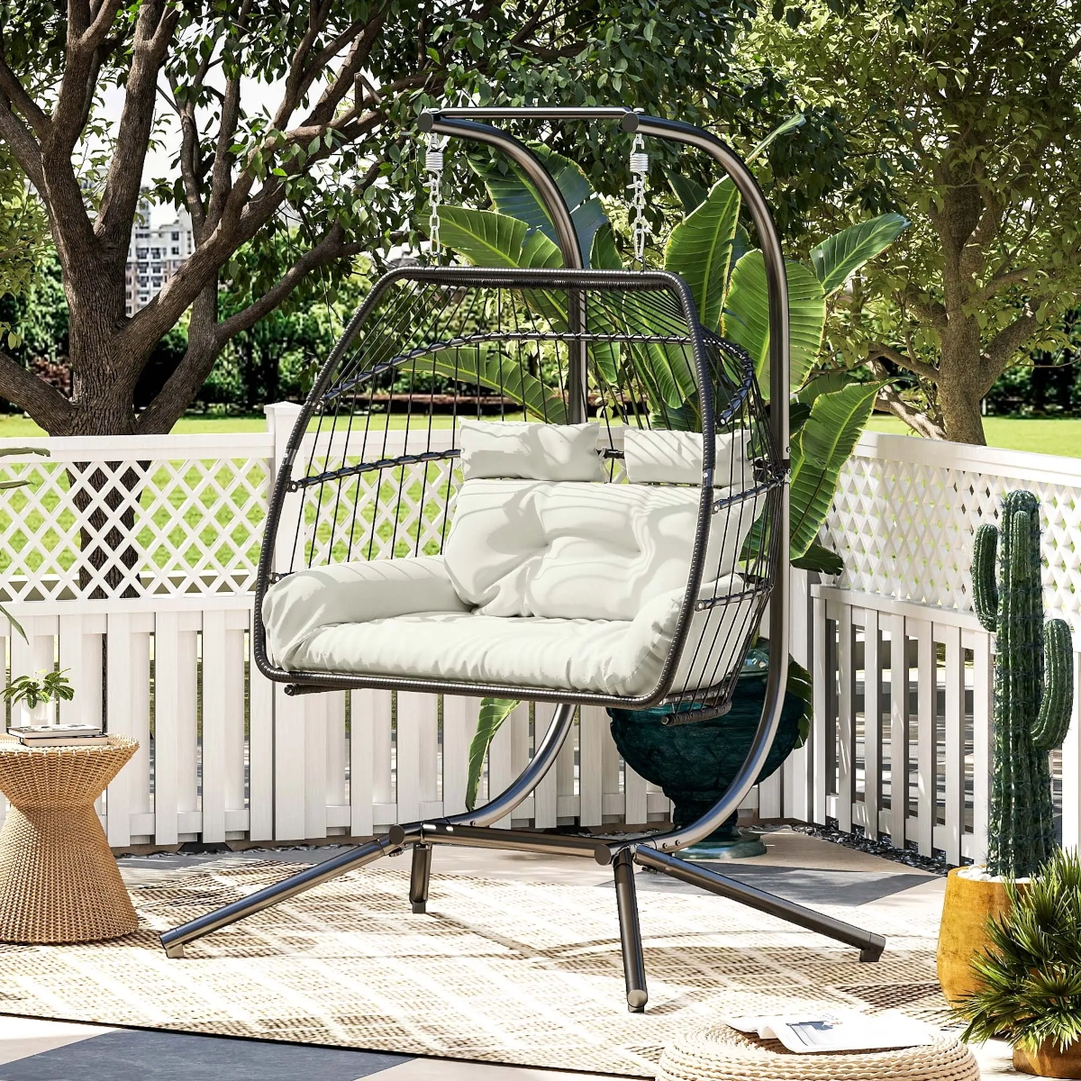 Spacious two-person wicker egg swing chair for patio seating with cozy cushions.