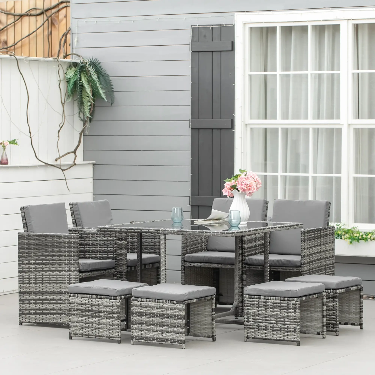 Stylish wicker patio dining set with glass table and cozy cushioned seating
