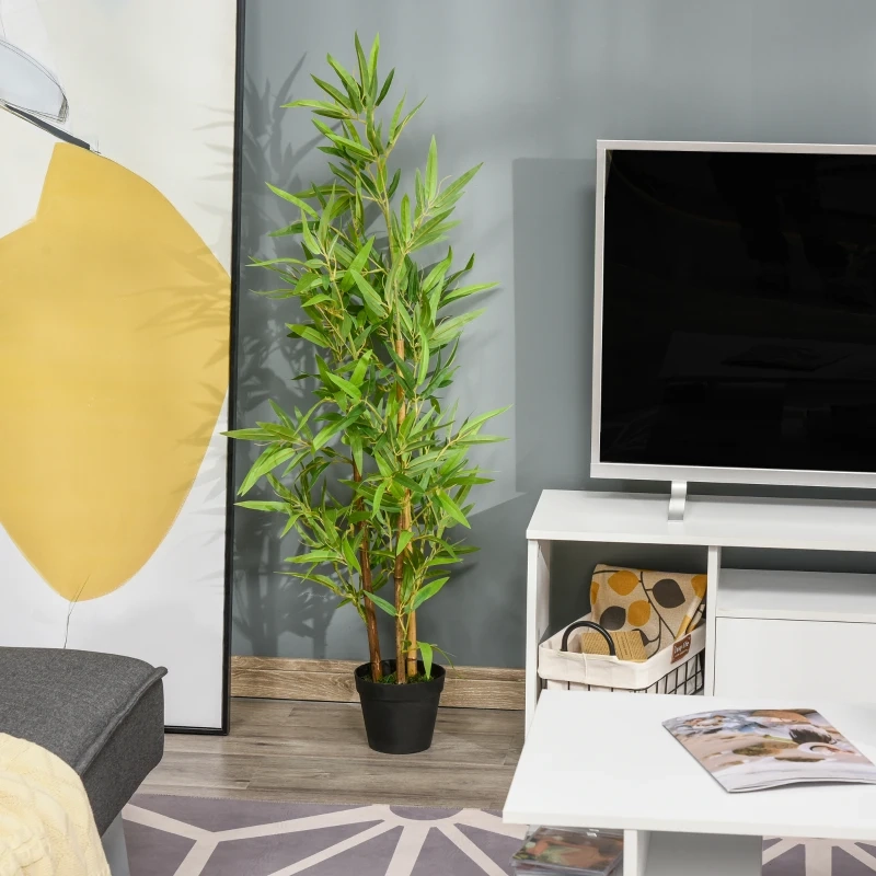 Lush artificial ficus tree in black pot beside grey armchair in cozy living room.