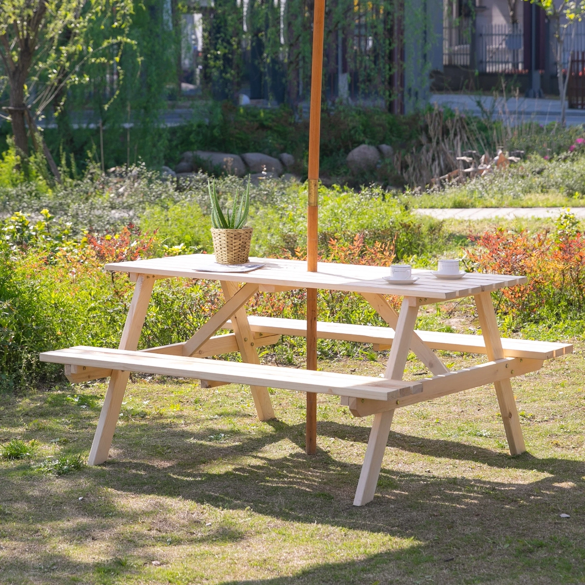 Finished wooden picnic table set in a green outdoor garden, ready for use.