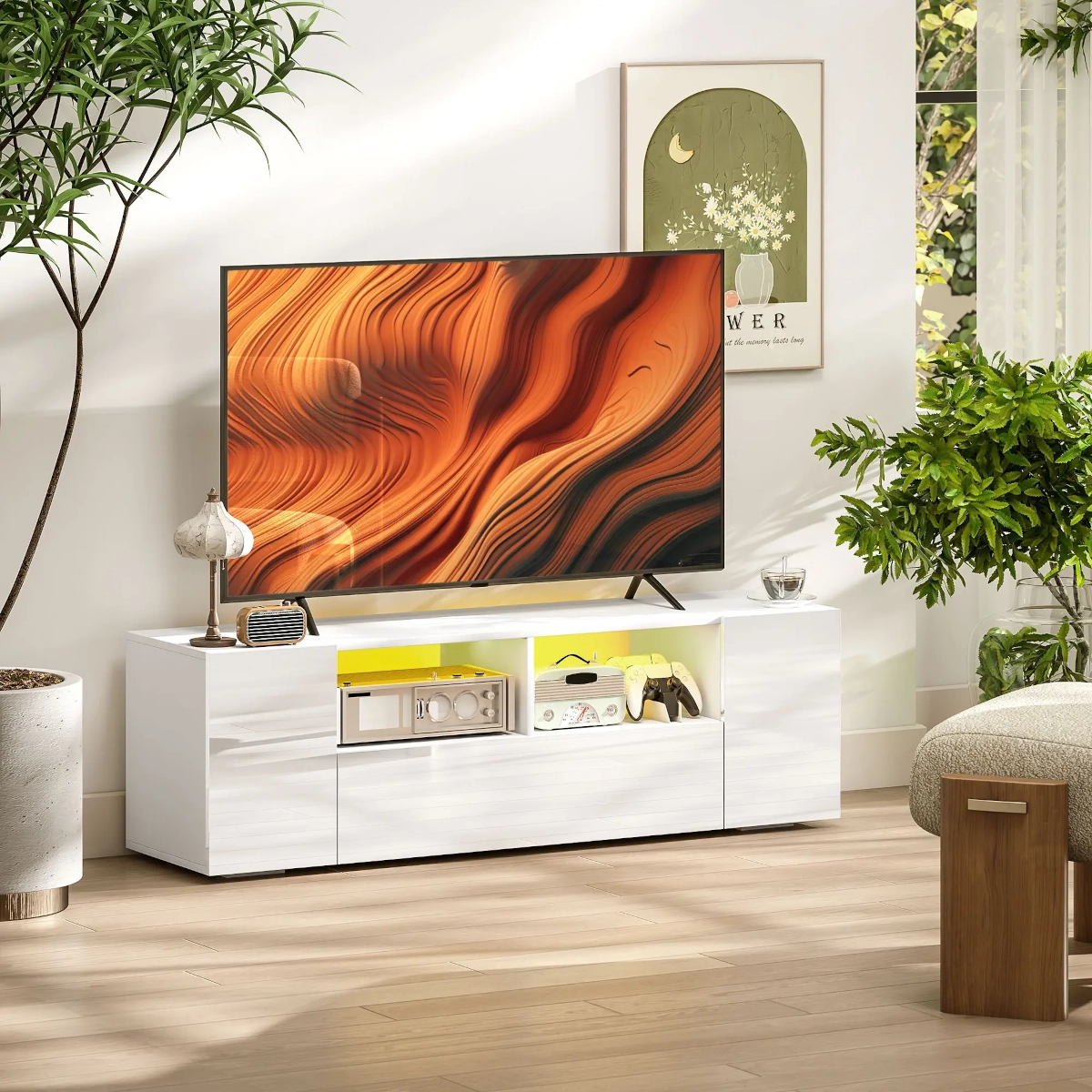 Bright living room with a glossy white TV stand featuring LED lighting and decorative accessories.