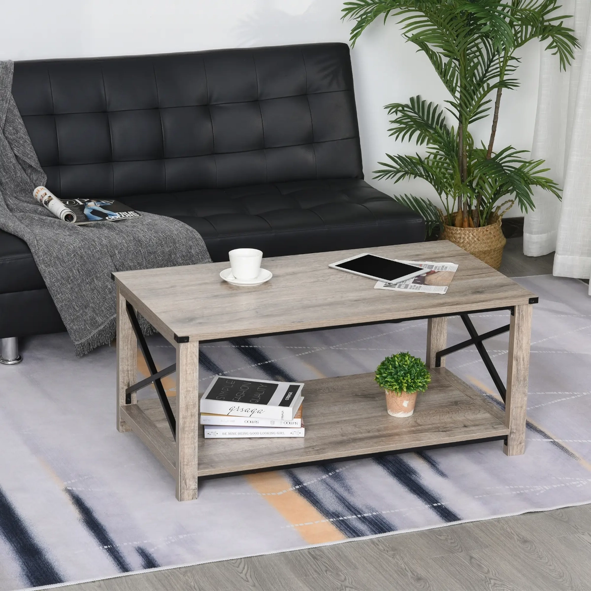 Modern wood and metal coffee table styled with books and plants in a contemporary living room.