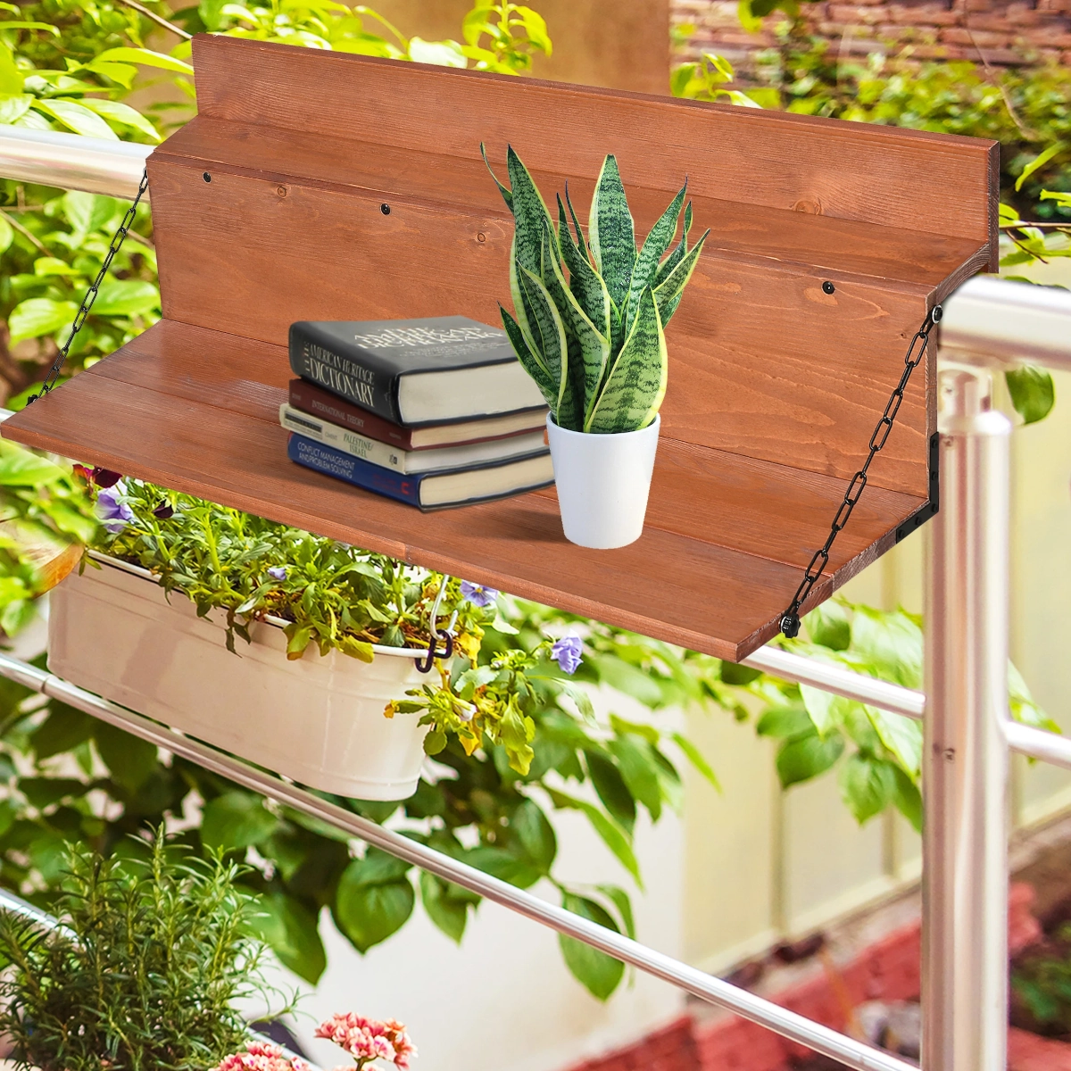 Wooden hanging balcony table holding books and a potted plant, above a flower planter.