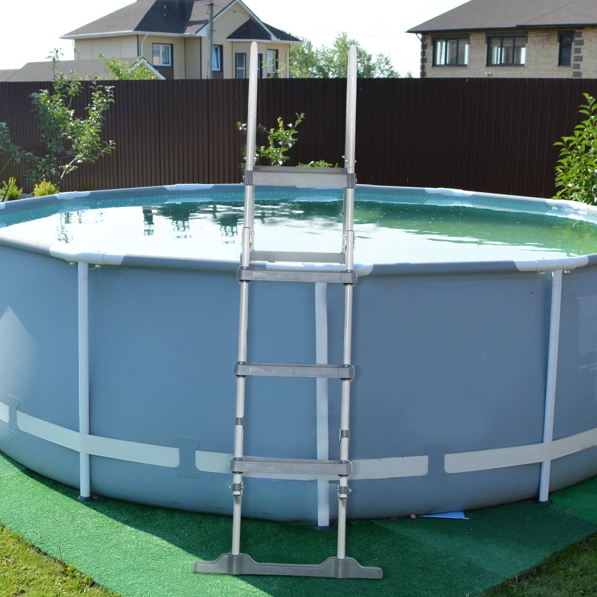 Completed above ground pool in backyard with clean water and assembled frame.