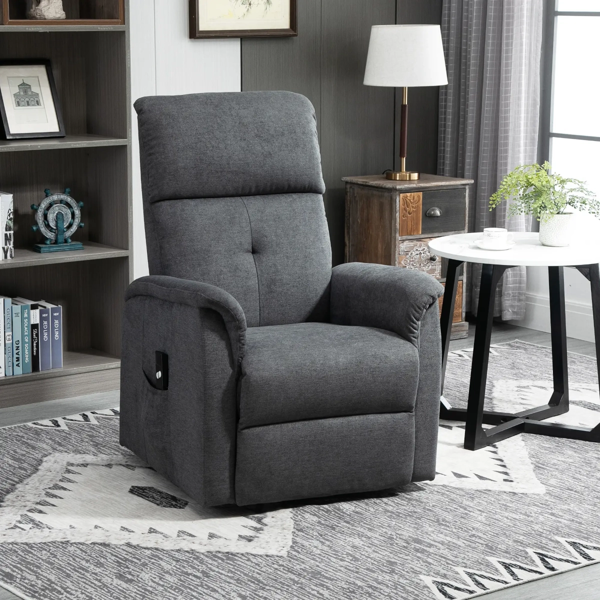 Comfortable gray fabric lift recliner with remote control and side pockets in a cozy living room.