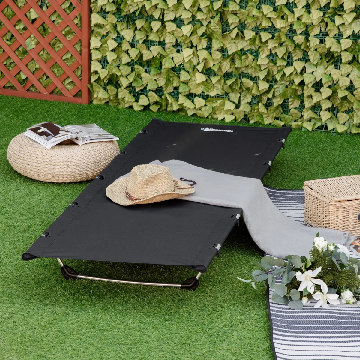 Slim, elevated aluminum camping cot with breathable fabric placed on rocky outdoor terrain.