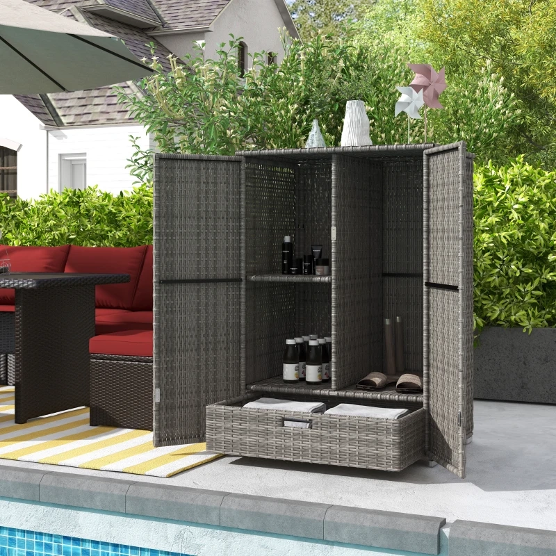 Modern patio setup with a woven storage box, cushions, and garden tools.