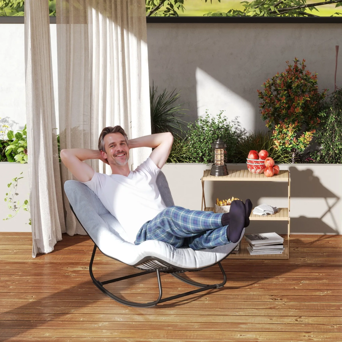 Large outdoor rattan egg chair with thick cushions for luxurious garden lounging experience.