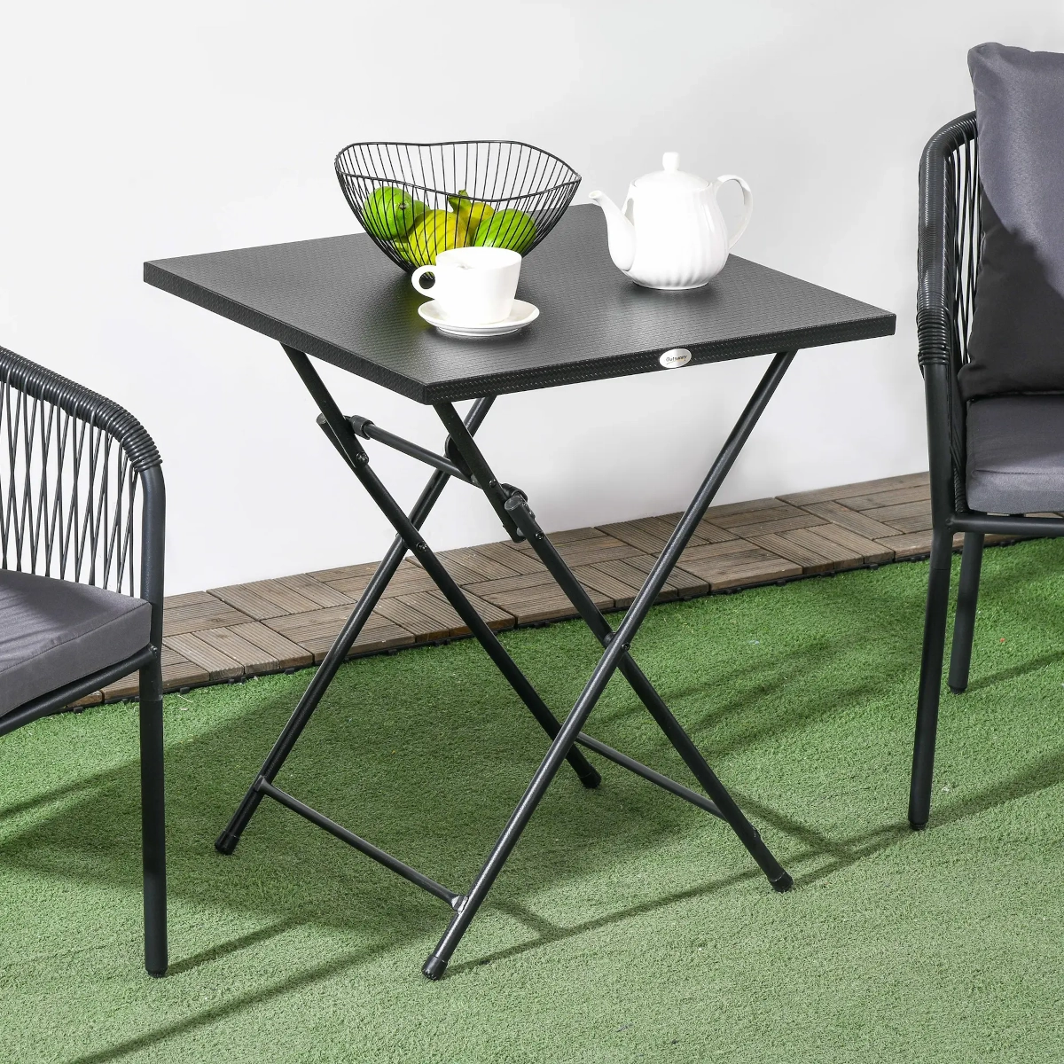 Foldable metal plate top table with textured surface, designed for easy storage.