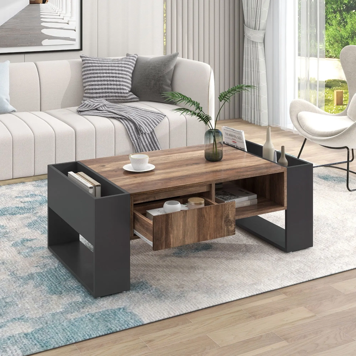 Modern living room with white sofa, wood and black coffee table featuring storage drawers and open shelves.