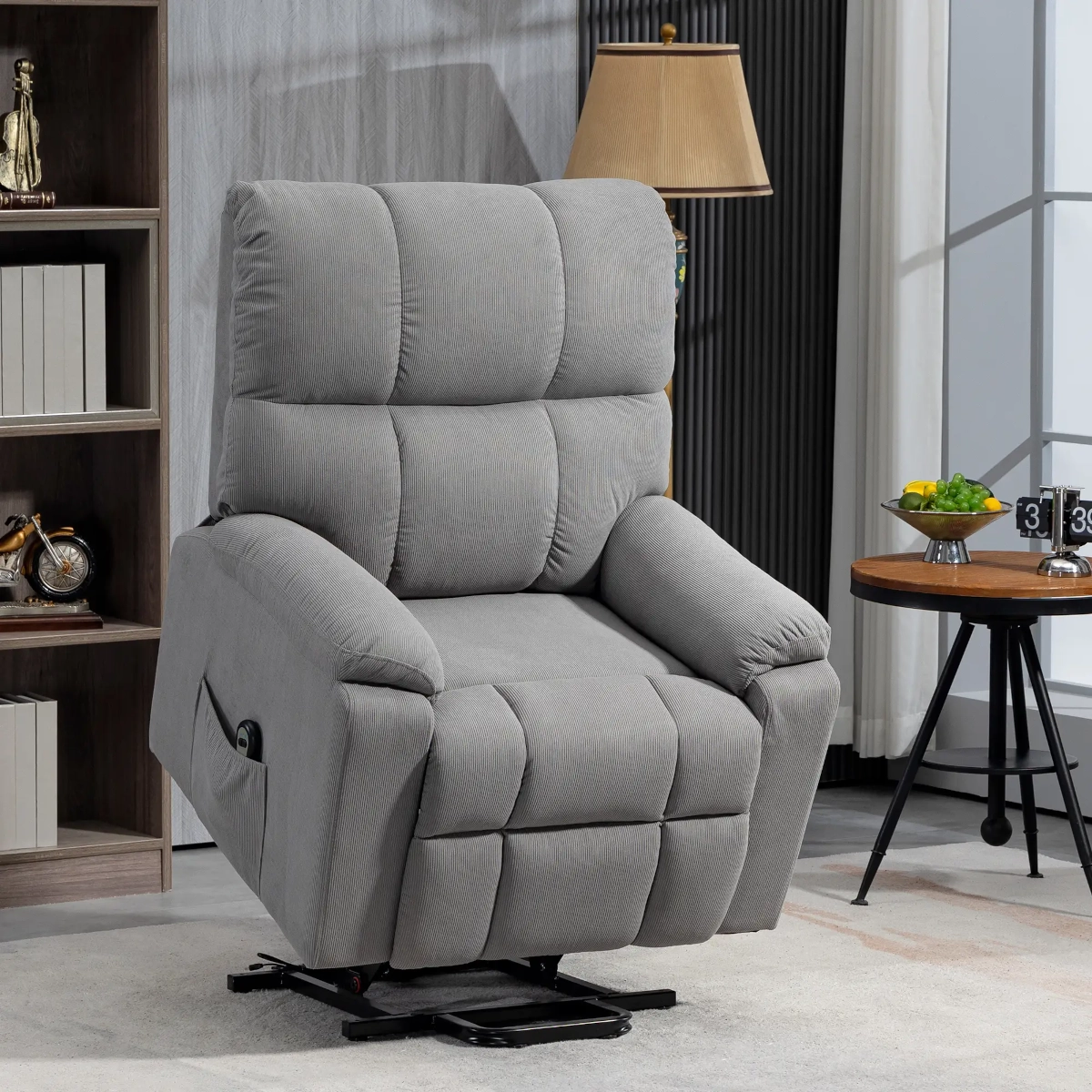 Grey fabric recliner chair with padded arms and backrest in a well-decorated home.