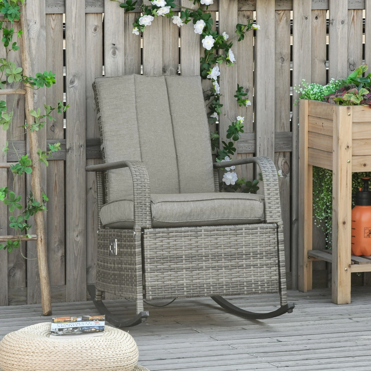 Reclining rocking chair with thick cushions and headrest in a sunlit backyard setting.