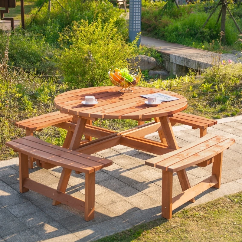 Round wooden picnic table with benches for outdoor garden or park seating