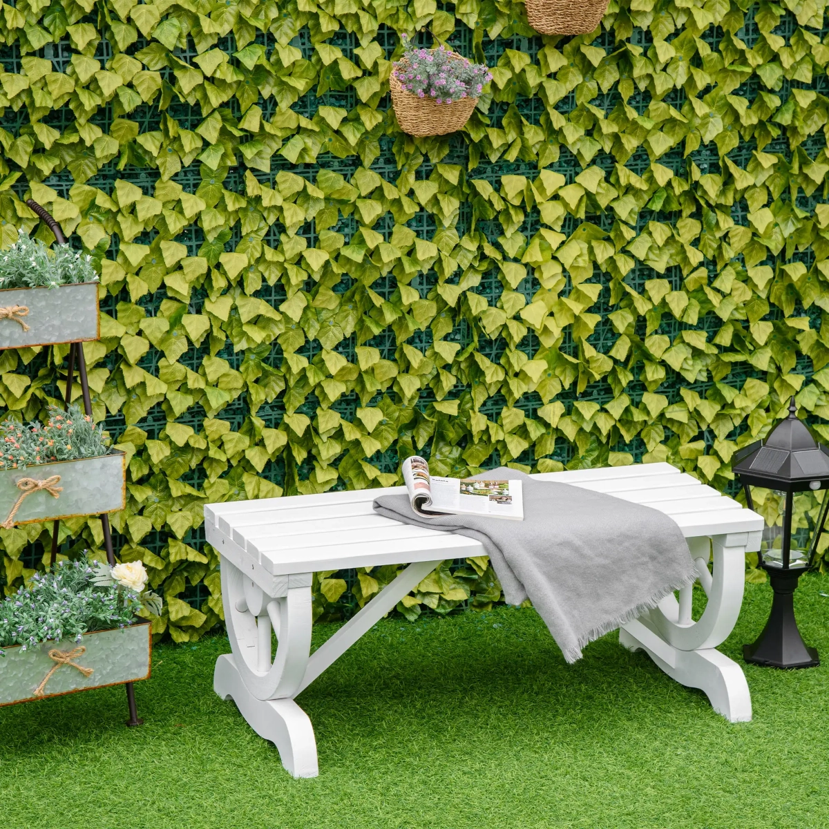 Wooden garden bench with wagon-wheel style legs placed on a grassy lawn.