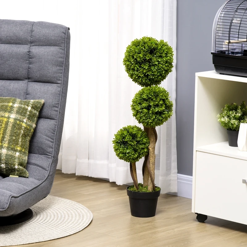 Two round artificial topiary trees in black pots on a white shelf.