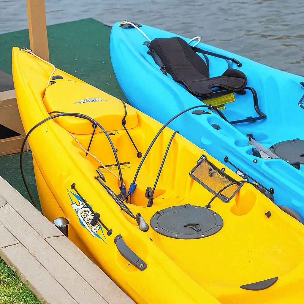 Blue sit-inside kayak on roof rack secured with strap featuring built-in locking system.