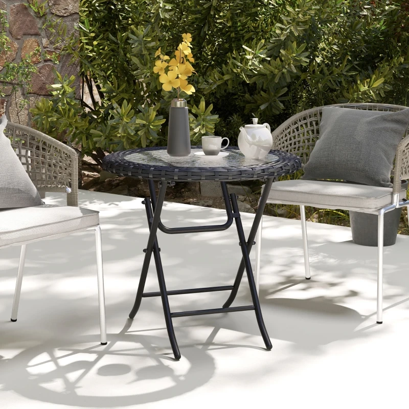 Elegant folding round glass top table with decorative metal frame, perfect for patios.