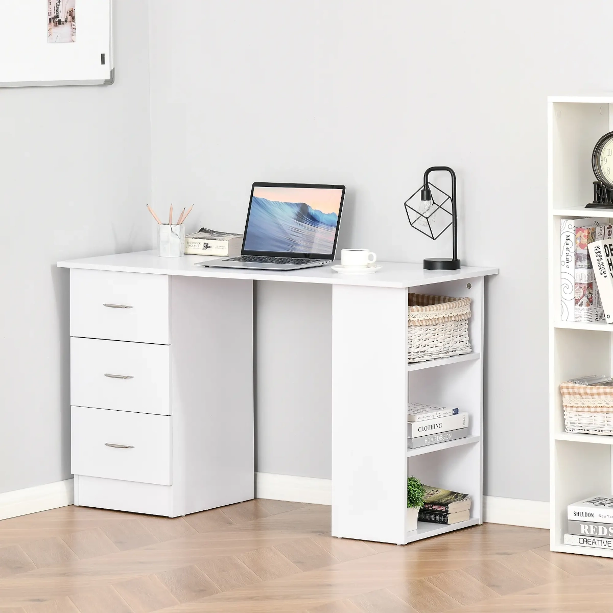 White L-shaped desk with drawers, shelves, laptop, and decor for a minimalist, organized workspace.