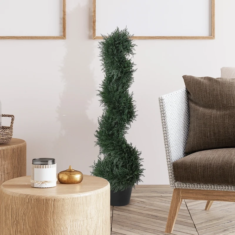 Spiral artificial topiary tree in black pot beside natural wood tables and modern accent chair.