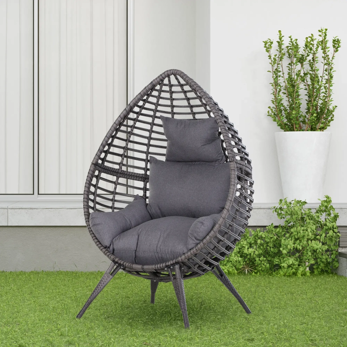 Cozy outdoor rattan egg chair with cushion, perfect for relaxing in garden settings