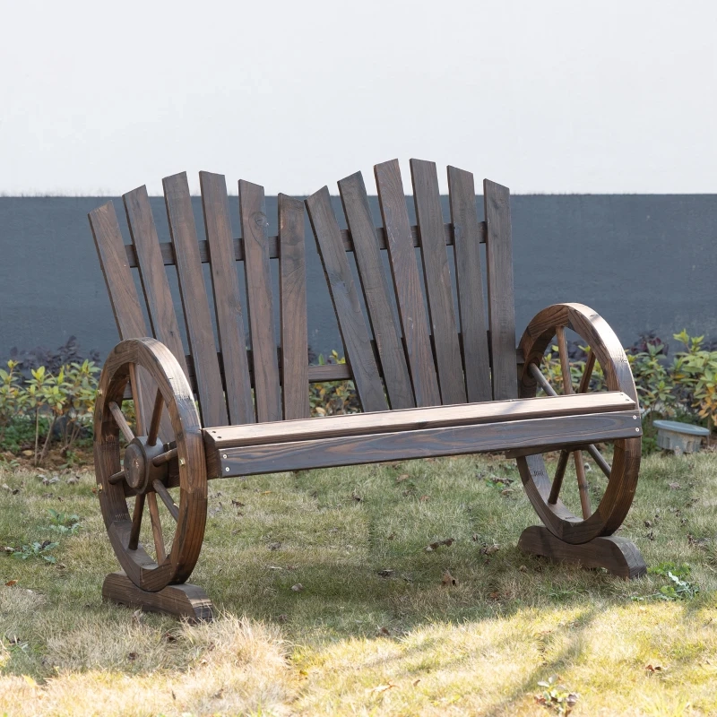 Dark wood outdoor bench with curved wheel-shaped armrests set on trimmed backyard grass.