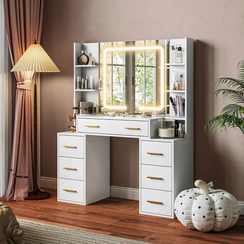 White vanity table with lighted mirror and multiple drawers beside modern décor and plush.