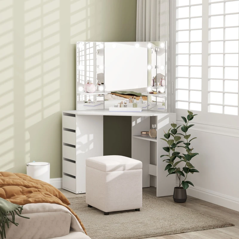 White corner vanity with Hollywood mirror, storage drawers, and stool in a modern bedroom.