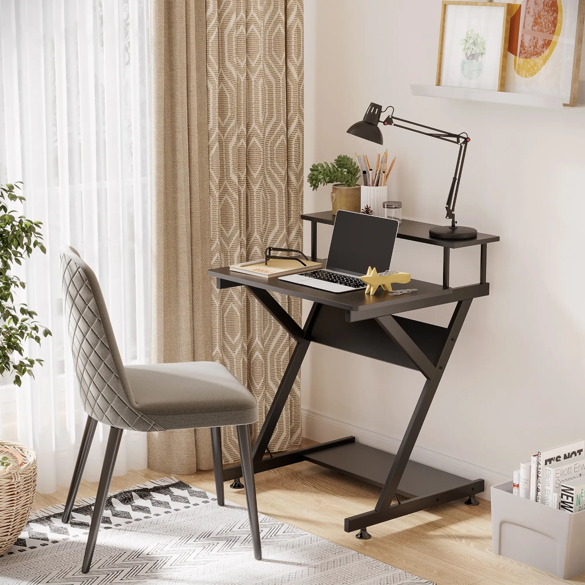 Small black desk with laptop, lamp, and chair.