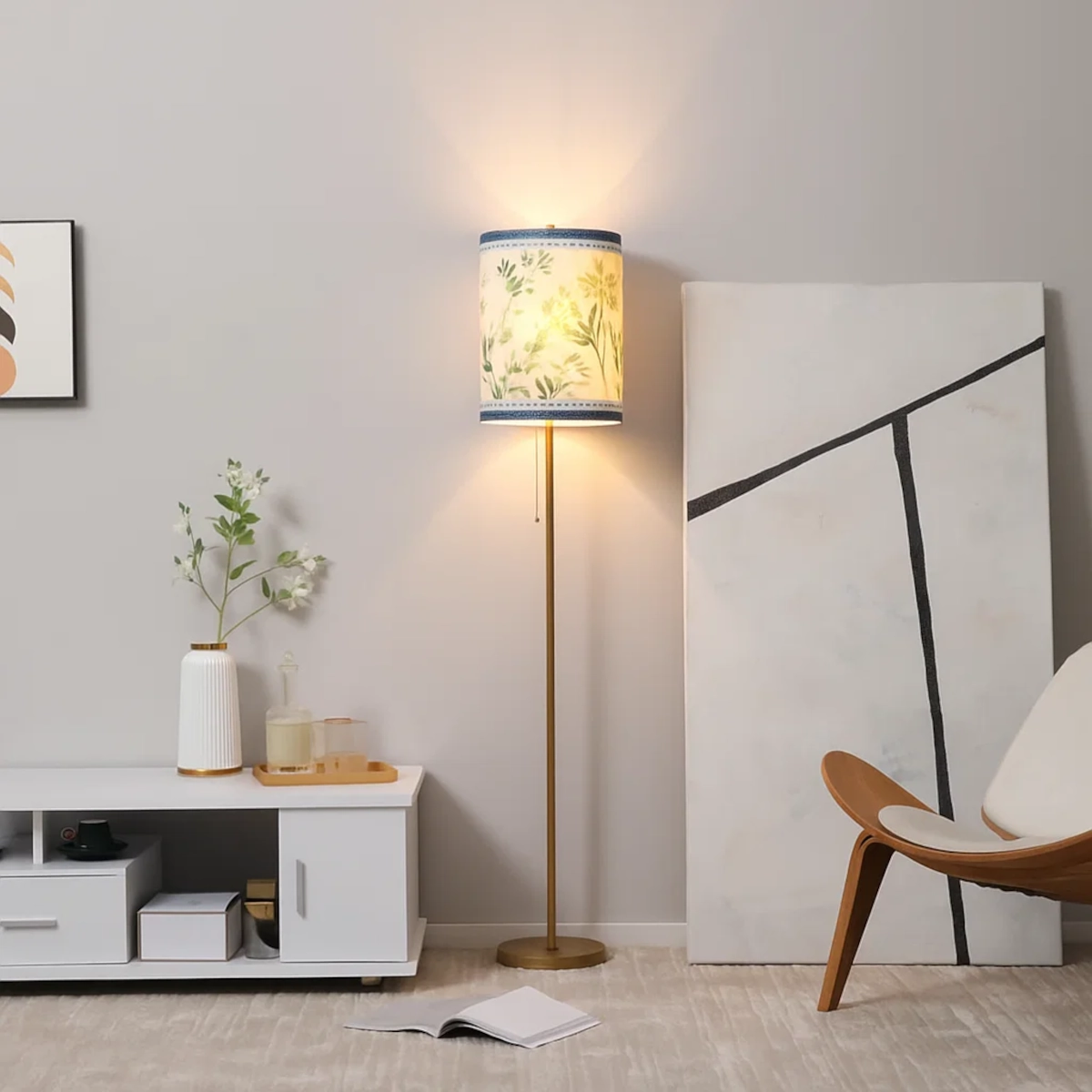 Floor lamp with a patterned lampshade featuring soft green floral designs, enhancing room ambience.