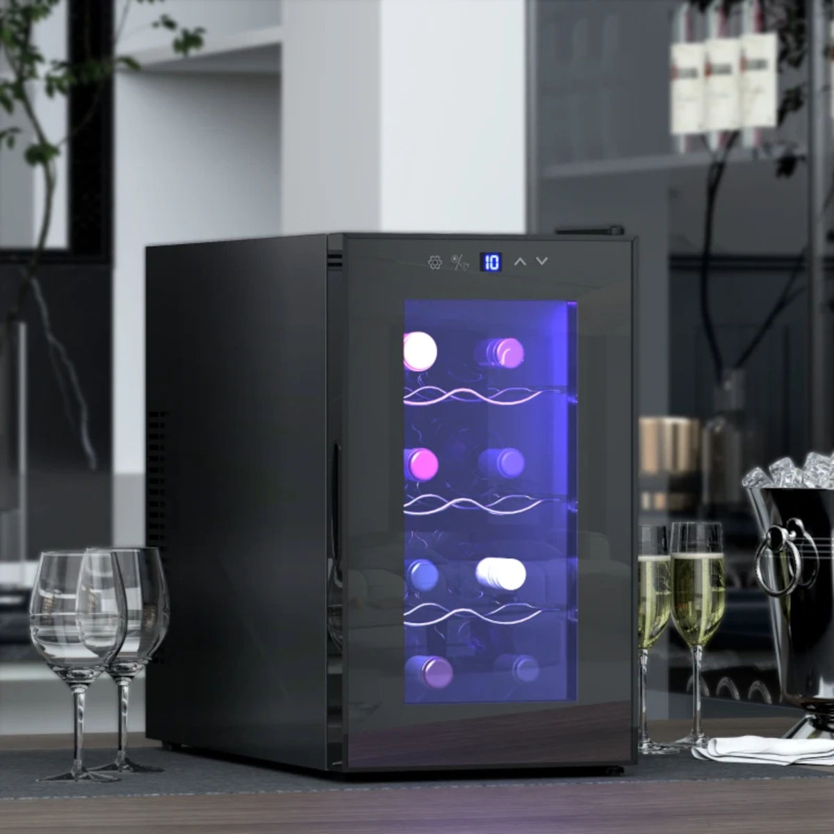 Stylish beverage fridge with interior lighting beside wine glasses and champagne bucket