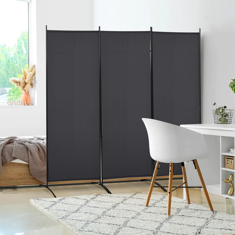 Black three-panel folding room divider separating bedroom from study area with white desk and modern chair.