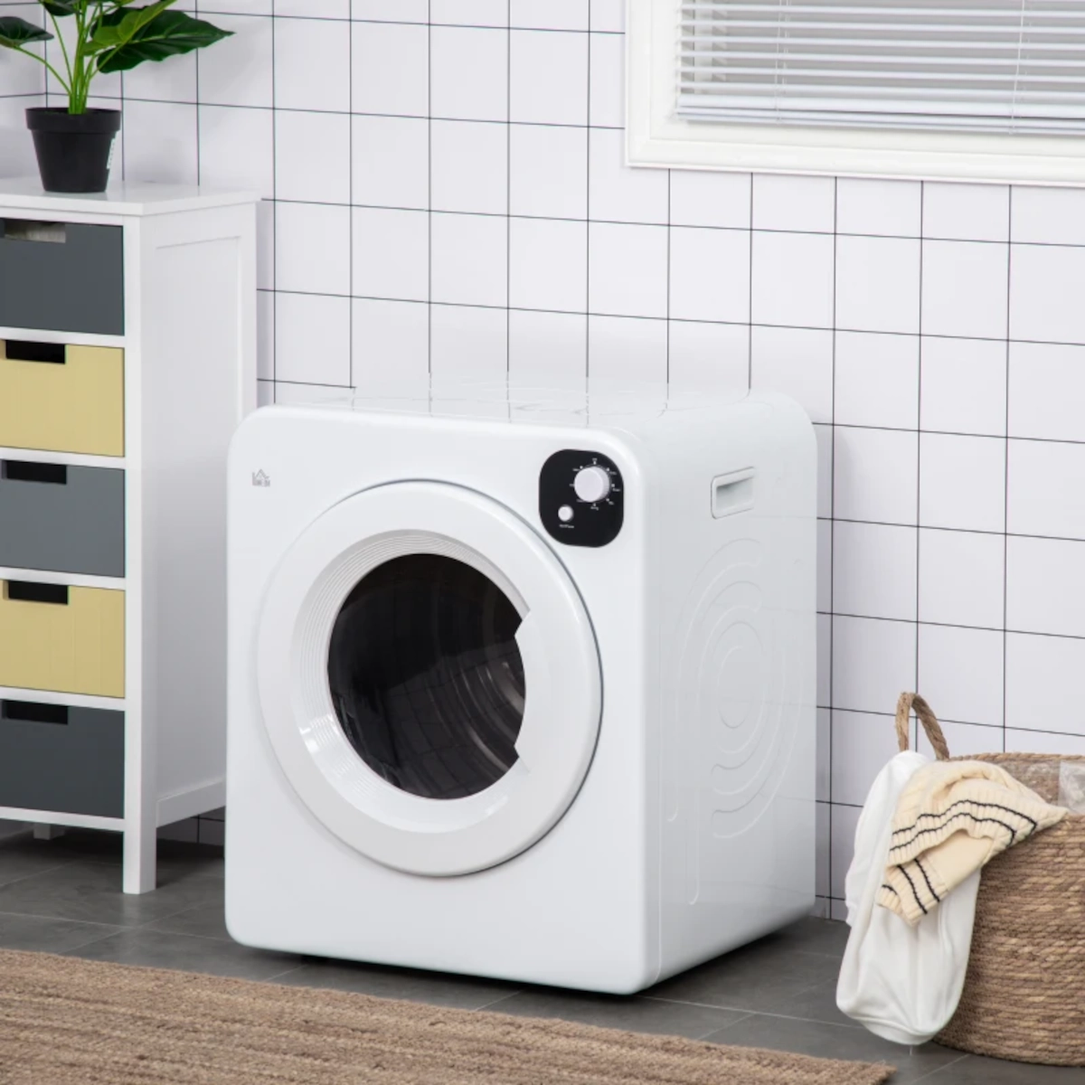 White front-load dryer in tiled laundry room with storage basket
