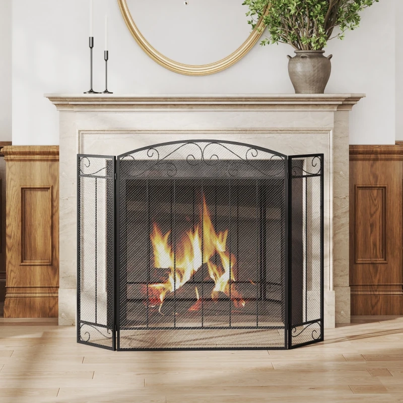 Elegant black mesh fireplace screen with decorative scroll design around a bright wood-burning fire.
