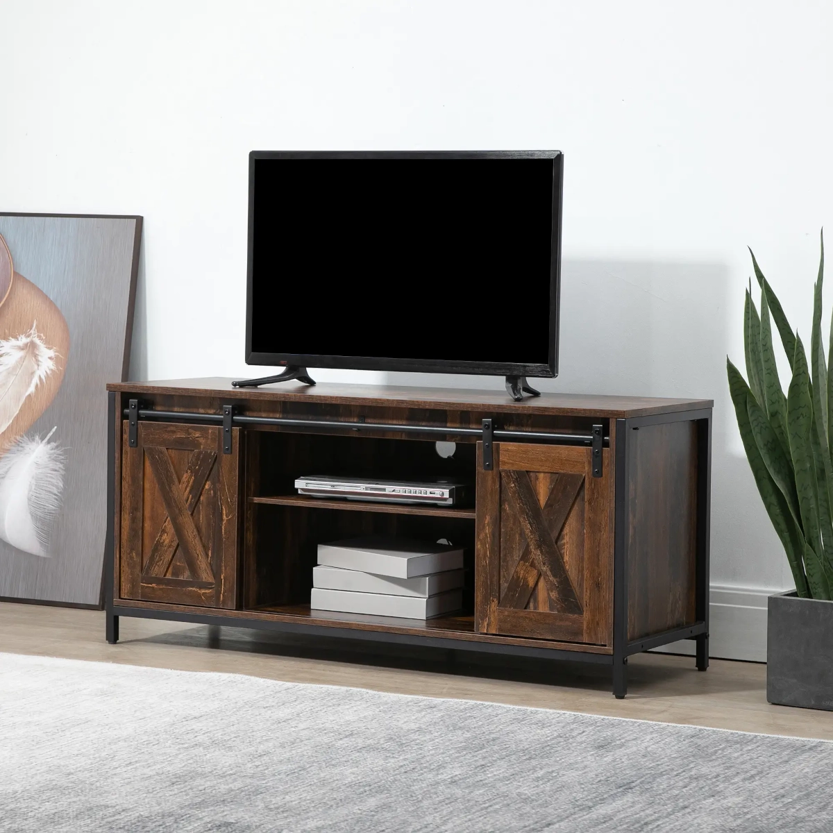 Rustic industrial TV stand with sliding barn doors and black metal frame supporting a flat-screen TV.
