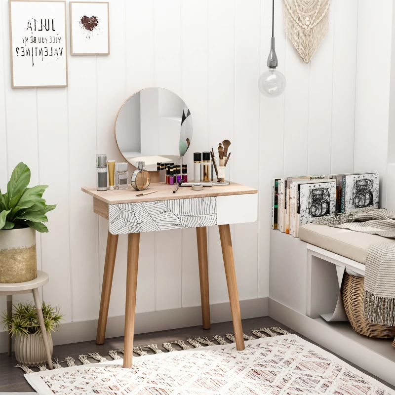 Small vanity with round mirror, makeup items, and modern chair in cozy, white-decorated corner space.
