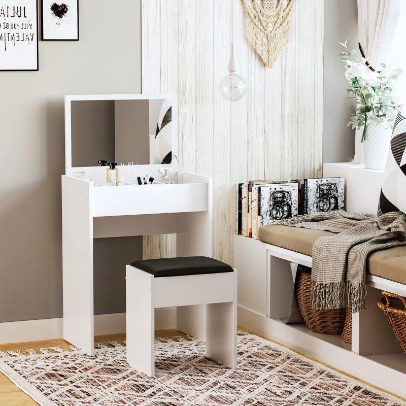 Compact white vanity with hidden storage mirror and stool, positioned in bright, minimalist corner with books.