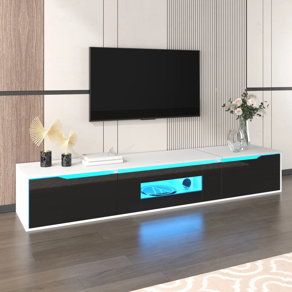 Low-profile black and white TV stand with blue LED lighting beneath modern décor and a mounted TV.