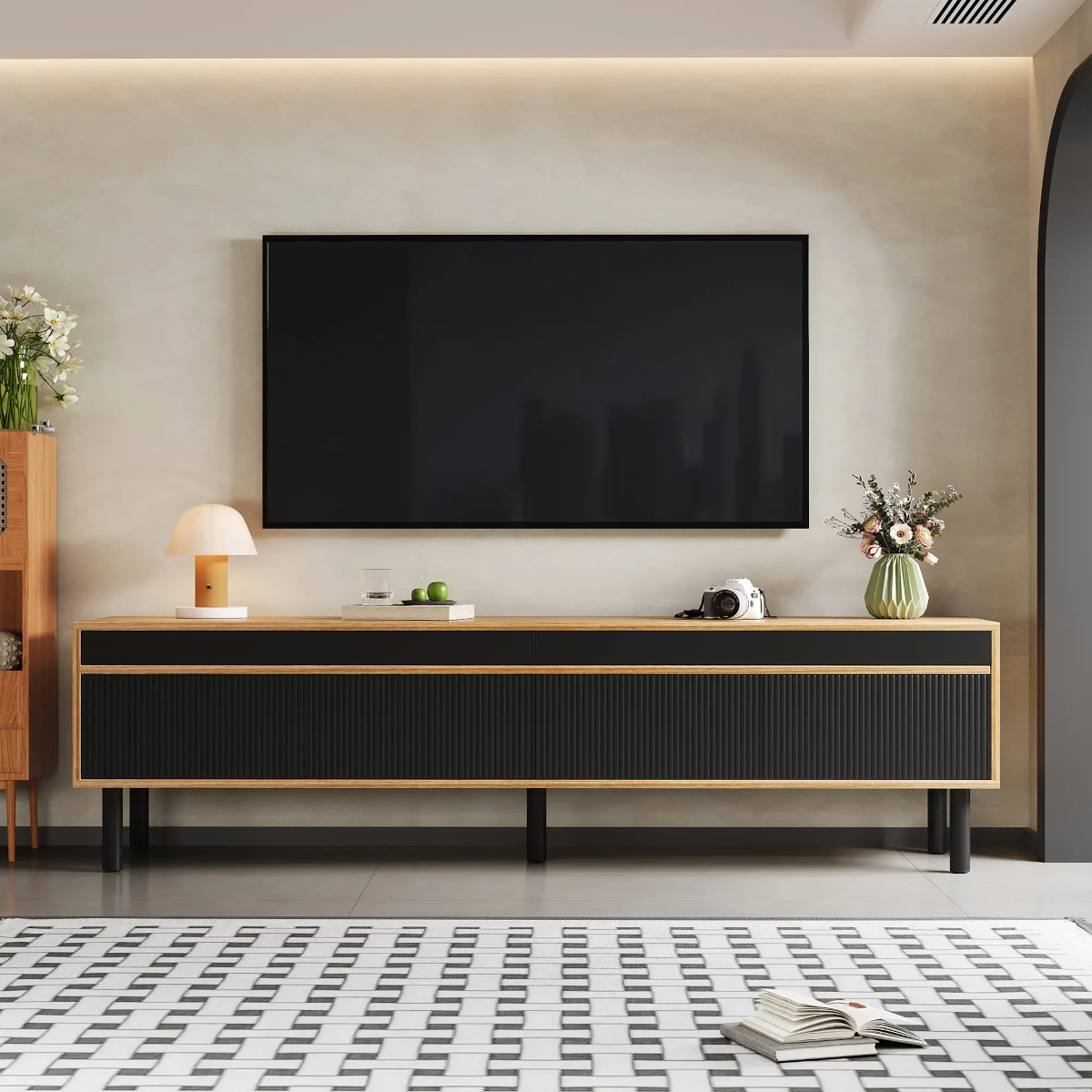 Modern black and wood TV stand with minimalist decor beneath a wall-mounted TV in a stylish living room.