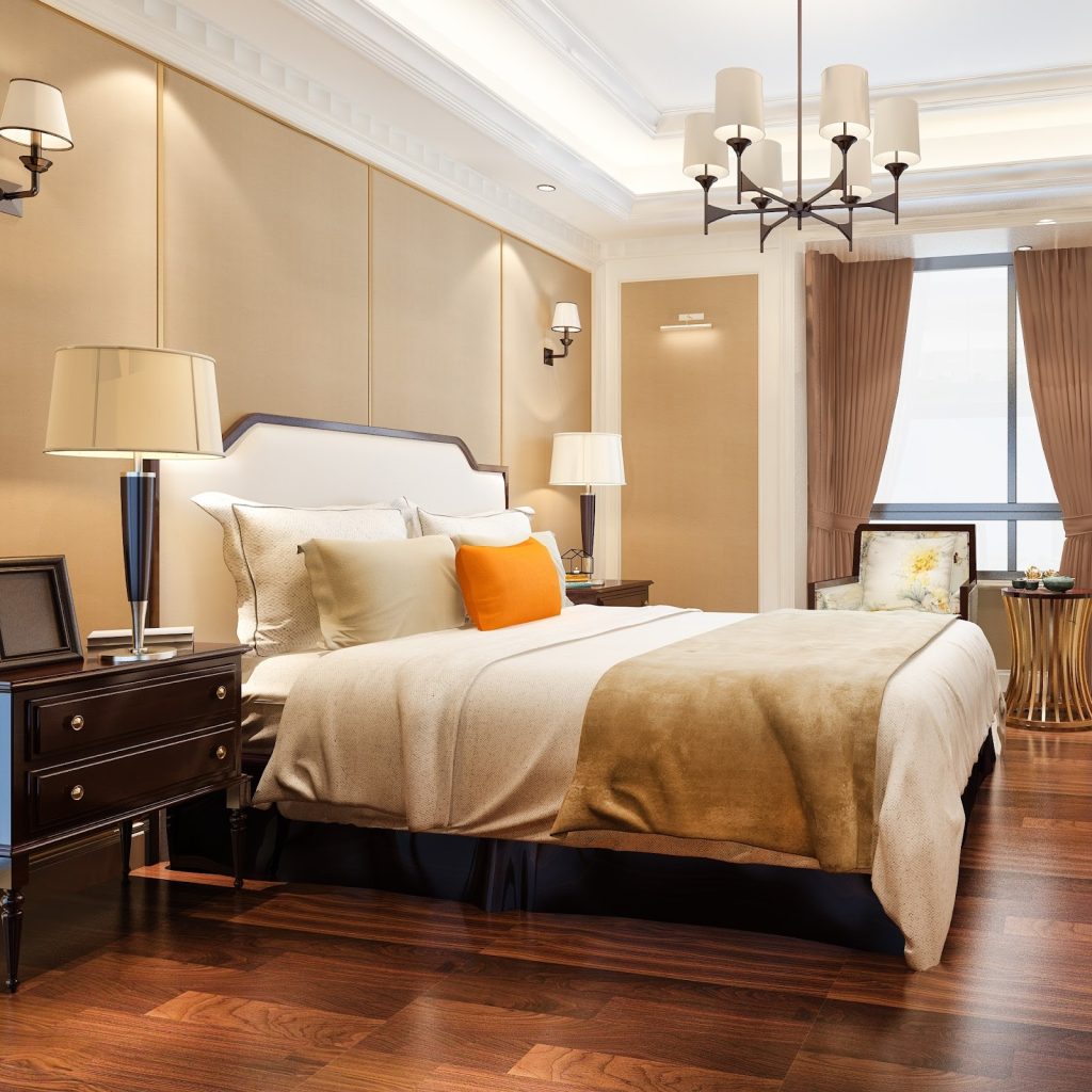 Elegant bedroom with soft lighting, cozy bedding, and decorative pillows.