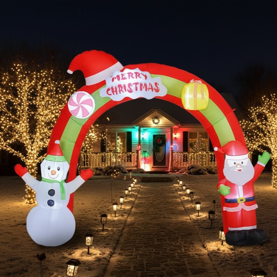 Lit Christmas archway at night with pathway lights and trees
